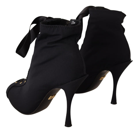 Black stretch ankle boots by Dolce & Gabbana featuring sleek design and pointed toes.
