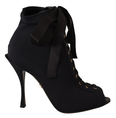 Black stretch ankle boots by Dolce & Gabbana with sleek design and pointed toes, showcasing the stylish footwear.