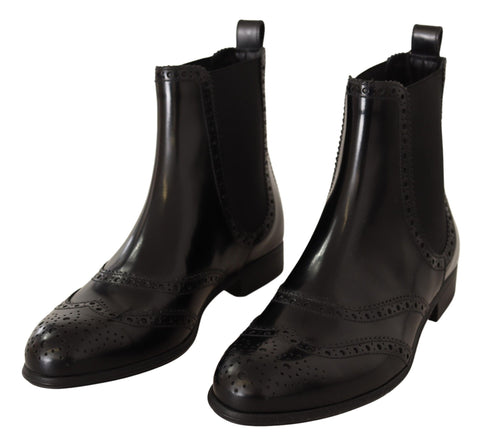 Black leather ankle-high flat boots by Dolce & Gabbana, featuring sleek design and classic silhouette.