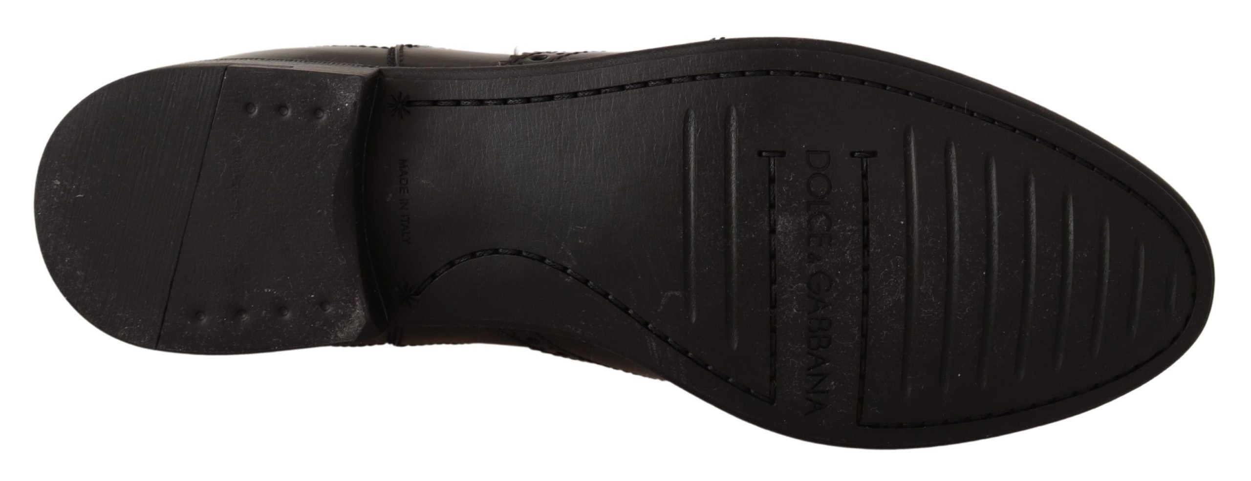 Black leather ankle high flat boots from Dolce & Gabbana, featuring sleek design and pointed toes.
