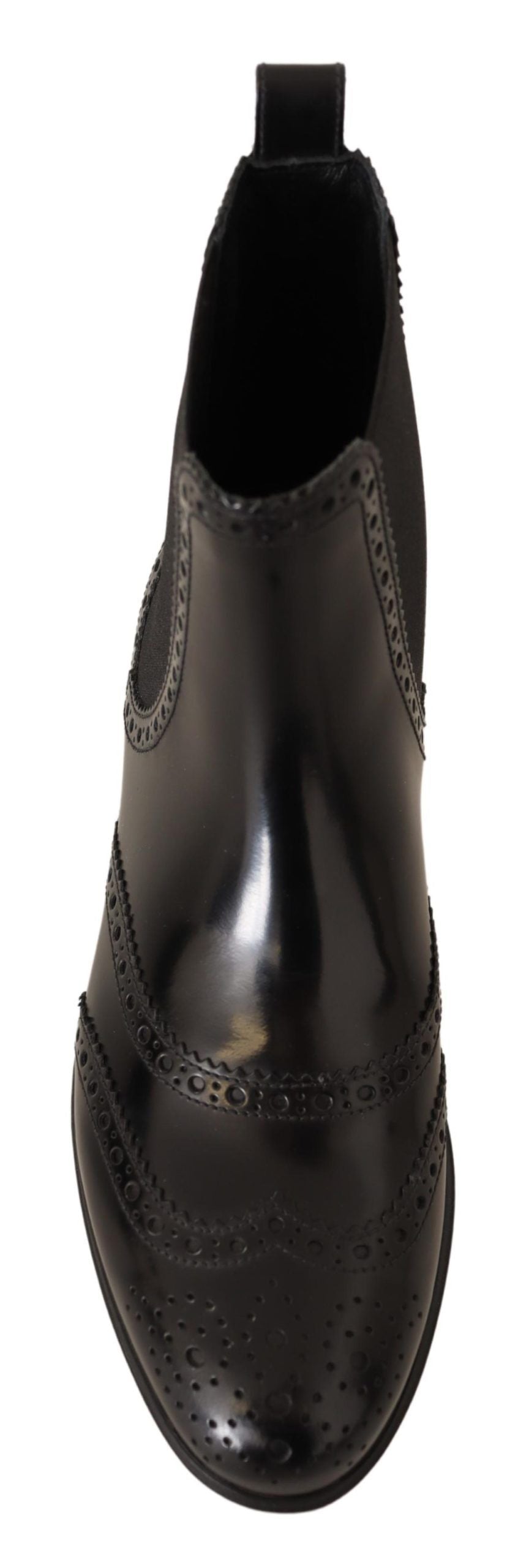 Black leather ankle high flat boots by Dolce & Gabbana, featuring sleek design and smooth finish, perfect for casual and stylish wear.