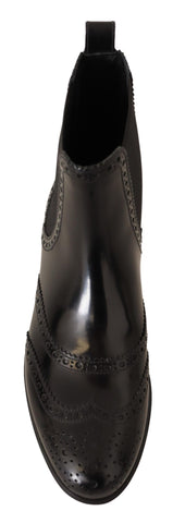 Black leather ankle high flat boots by Dolce & Gabbana, featuring sleek design and smooth finish, perfect for casual and stylish wear.