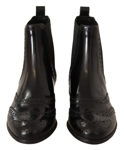 Black leather ankle high flat boots from Dolce & Gabbana with sleek design and rounded toes.
