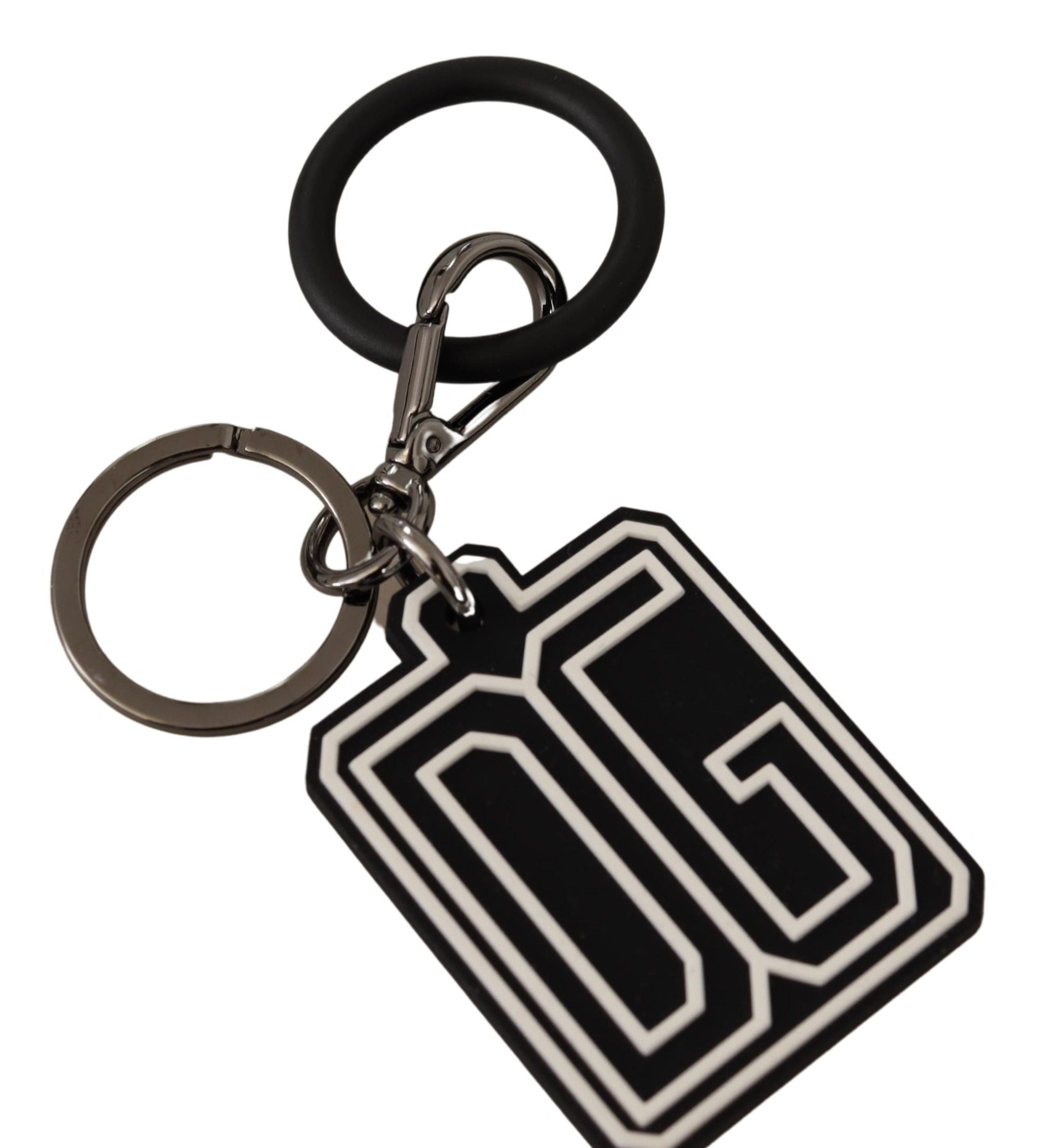 Black and white Dolce & Gabbana rubber logo silver ring keychain with engraved branding and sleek design.