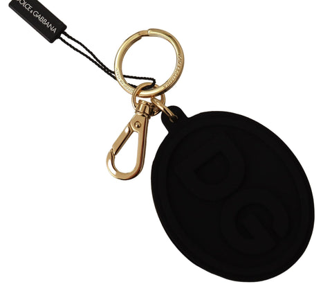 Black rubber Dolce & Gabbana keyring with gold brass DG logo, metal keychain accessory with branded design.