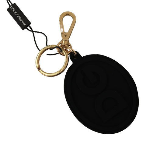 Black rubber Dolce & Gabbana keyring with gold brass DG logo and metal keychain attachment.