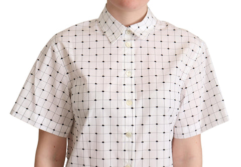 White cotton collared shirt top with black polka dots by Dolce & Gabbana, shown with short sleeves and button-up front.