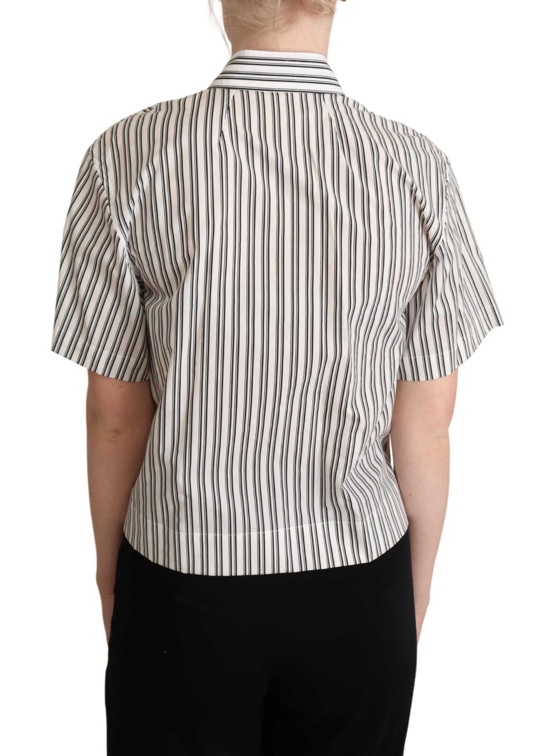White and black striped Dolce & Gabbana blouse top with long sleeves and classic collar, shown on a hanger.