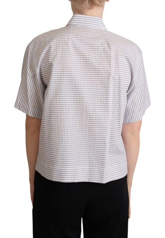 White collared blouse with black polka dots by Dolce & Gabbana, featuring a stylish button-up front and long sleeves.