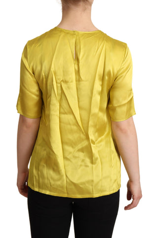 Yellow silk short sleeve blouse by Dolce & Gabbana, featuring a classic T-shirt style with a smooth, luxurious fabric.