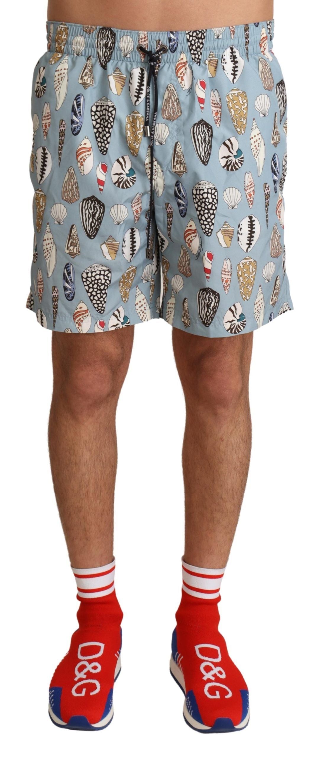 Blue seashell print Dolce & Gabbana swimwear shorts with a relaxed fit, designed for beachwear and swim activities.