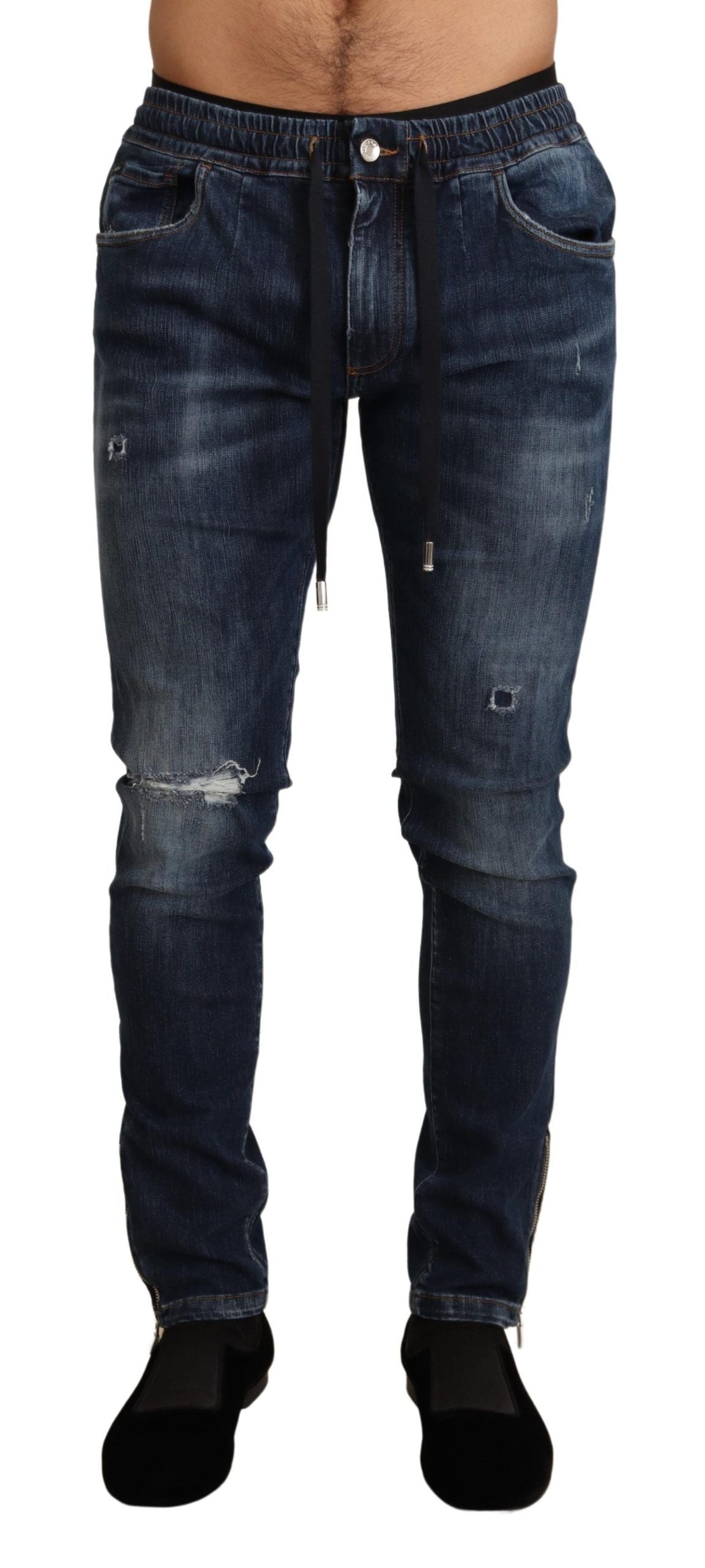 Blue cotton stretch tattered denim jeans by Dolce & Gabbana, showcasing distressed design and slim fit silhouette.