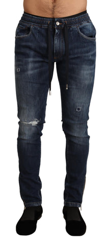Blue cotton stretch tattered denim jeans by Dolce & Gabbana, showcasing distressed design and slim fit silhouette.