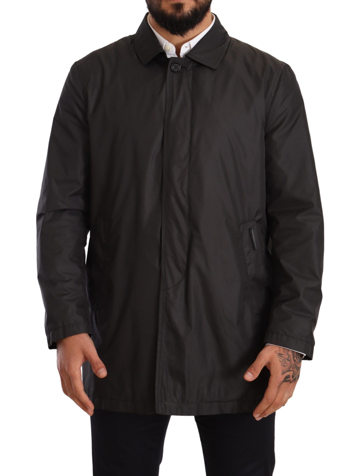 Black polyester men's trench coat jacket by Dolce & Gabbana, shown hanging with classic collar and button details.