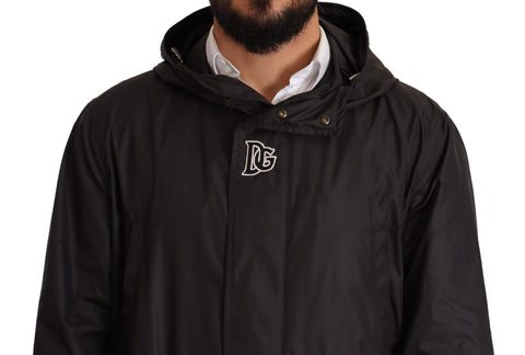 Black hooded men's trench coat jacket by Dolce & Gabbana, featuring a sleek design and button details.