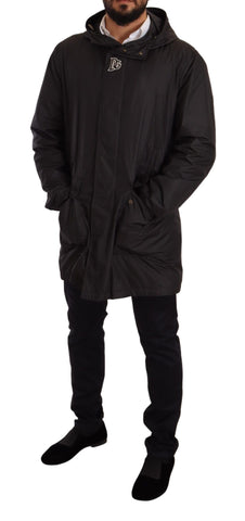 Black hooded men's trench coat jacket by Dolce & Gabbana, featuring a sleek design and classic silhouette.