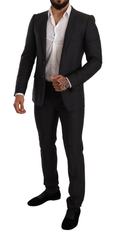 Gray wool Martini slim fit suit set by Dolce & Gabbana, featuring tailored jacket and matching trousers on a hanger.