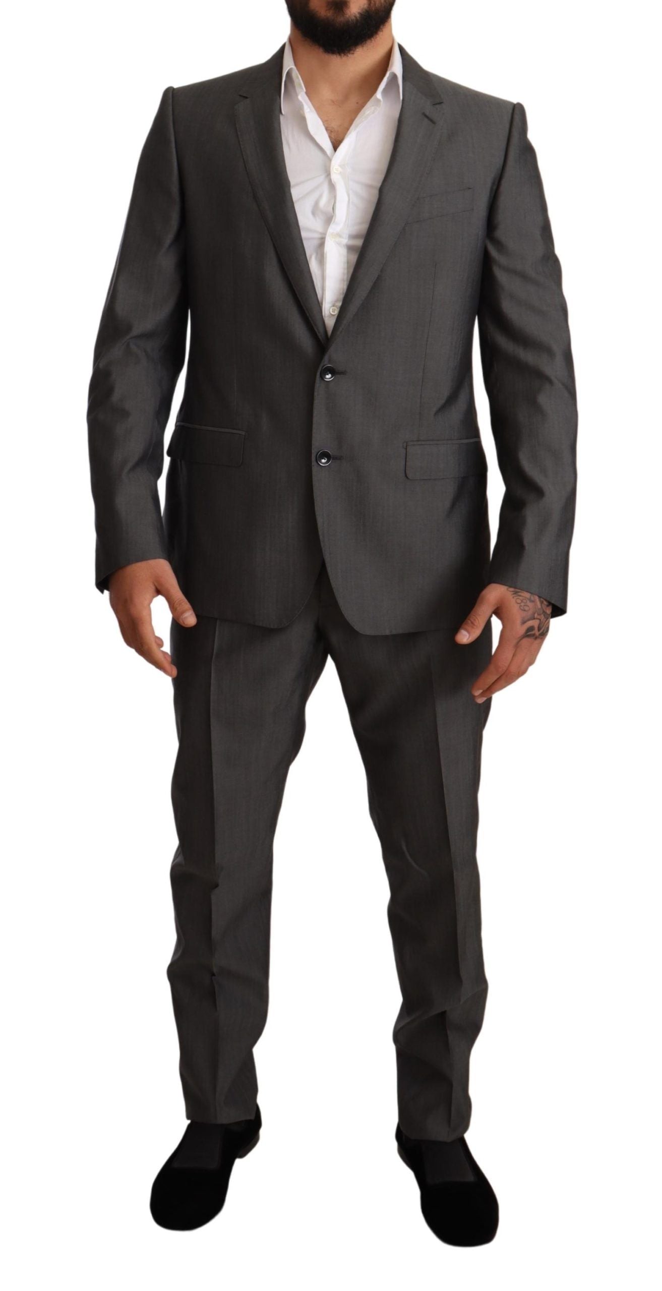 Gray metallic Martini slim fit suit set by Dolce & Gabbana, featuring tailored jacket and matching trousers on a hanger.