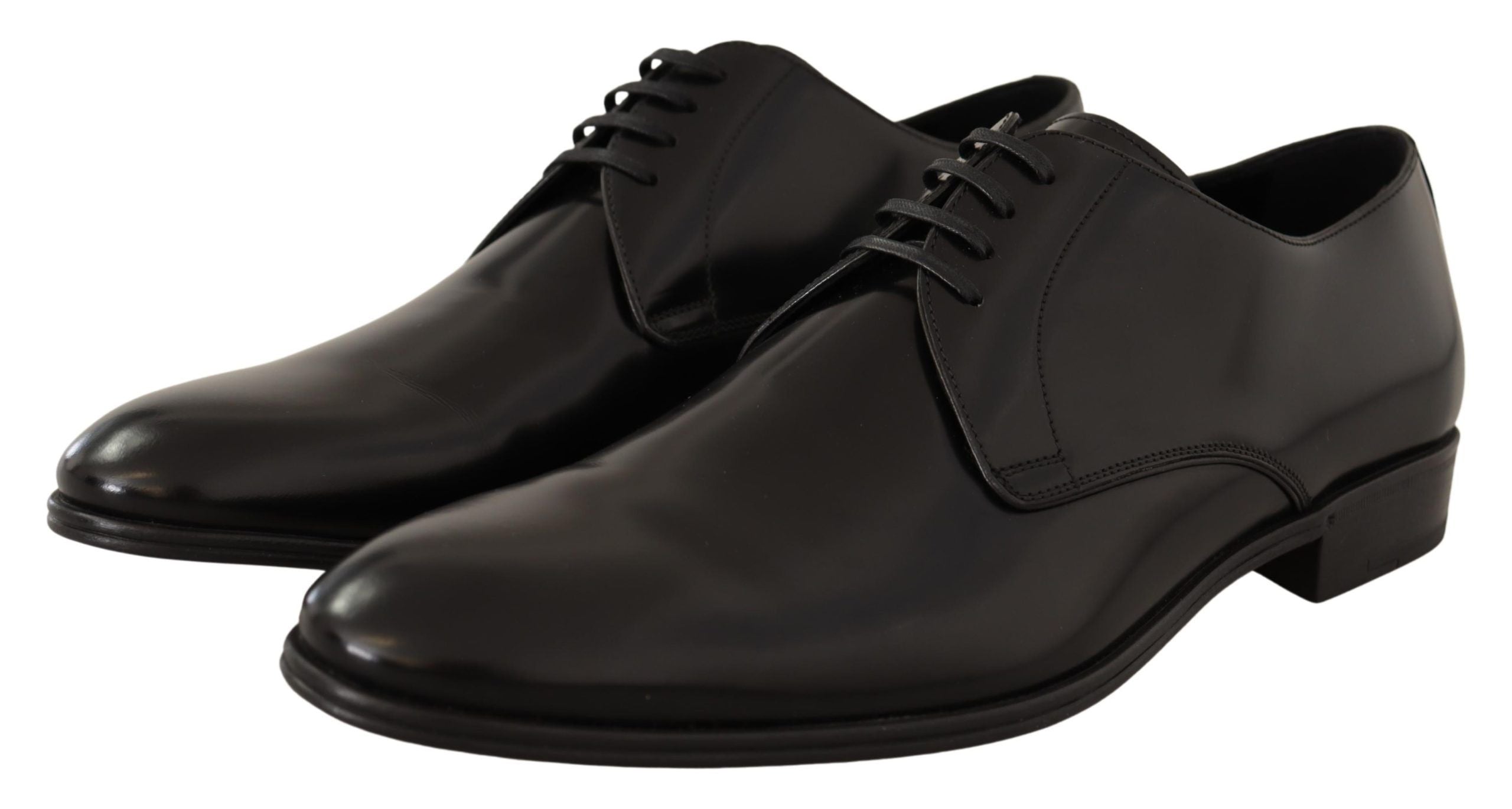 Dolce & Gabbana black leather lace-up men's dress derby shoes on a plain background.