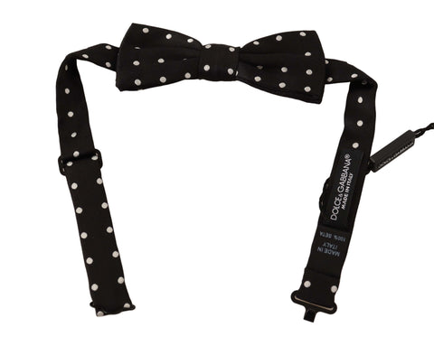 Black and white polka dot silk bow tie with adjustable neck strap by Dolce & Gabbana, featuring a classic papillon style.