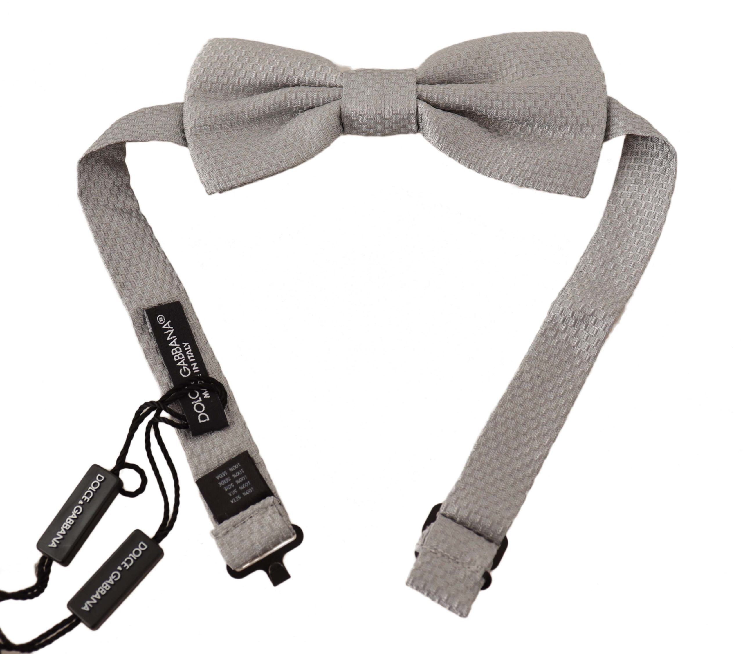 Silver gray 100% silk adjustable bow tie featuring a papillon design by Dolce & Gabbana, tied in a classic bow shape.