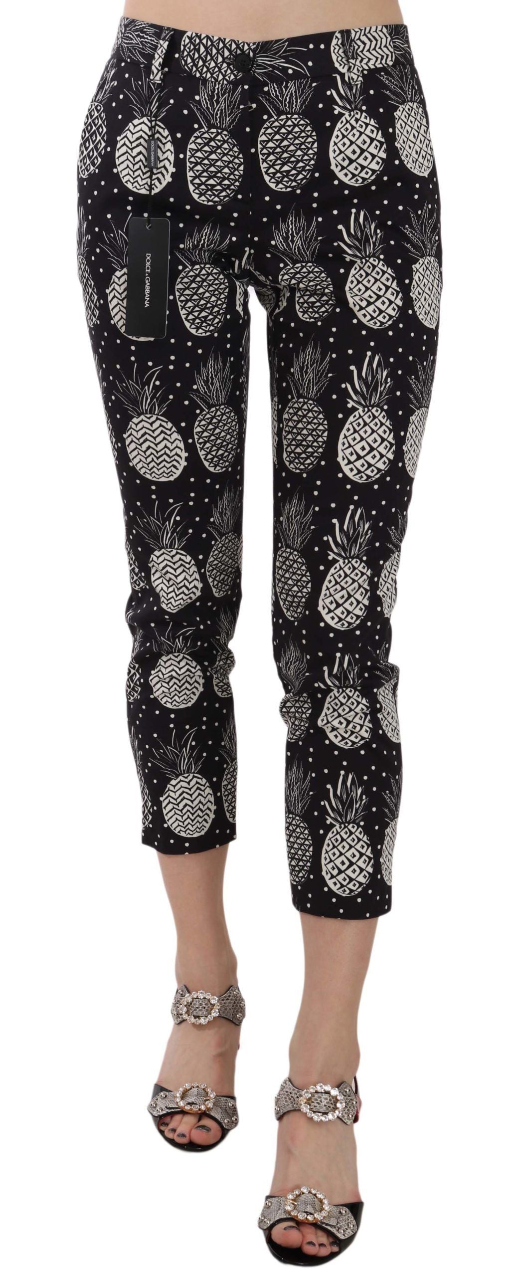 Dolce & Gabbana black pineapple print skinny Capri pants with fitted style and vibrant tropical pattern.