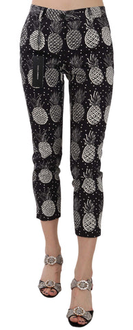 Dolce & Gabbana black pineapple print skinny Capri pants with fitted style and vibrant tropical pattern.