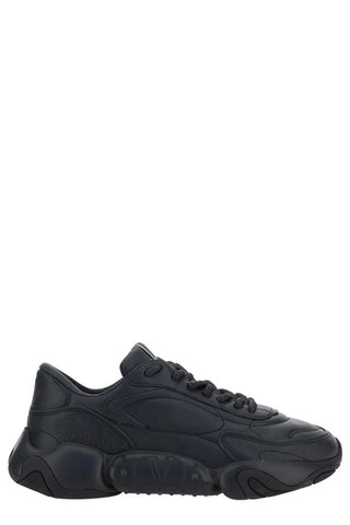 Valentino Garavani black calf leather sneakers with sleek design and white rubber soles, front view showing stylish details.