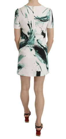White, black, and blue Dolce & Gabbana mini dress featuring a stylish shift design, short length, and vibrant color block pattern.
