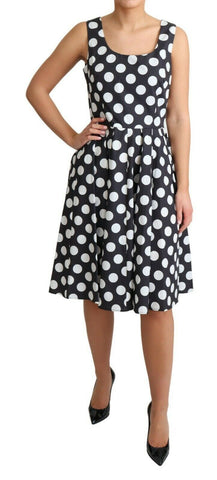 Black polka dotted cotton A-line dress by Dolce & Gabbana, featuring a classic silhouette and playful pattern.