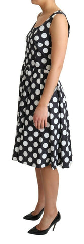 Black polka dotted cotton A-line dress by Dolce & Gabbana, featuring a classic fit and stylish pattern, shown on a model.