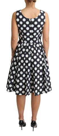 Black polka dotted cotton A-line dress by Dolce & Gabbana, featuring a classic fit and playful pattern.