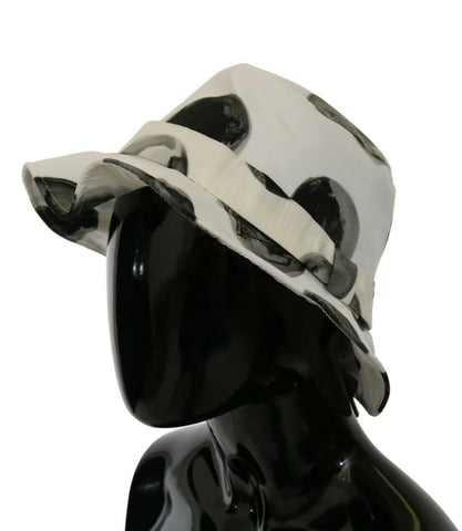 White cotton bucket hat with large black polka dot pattern by Dolce & Gabbana, shown from a front angle.