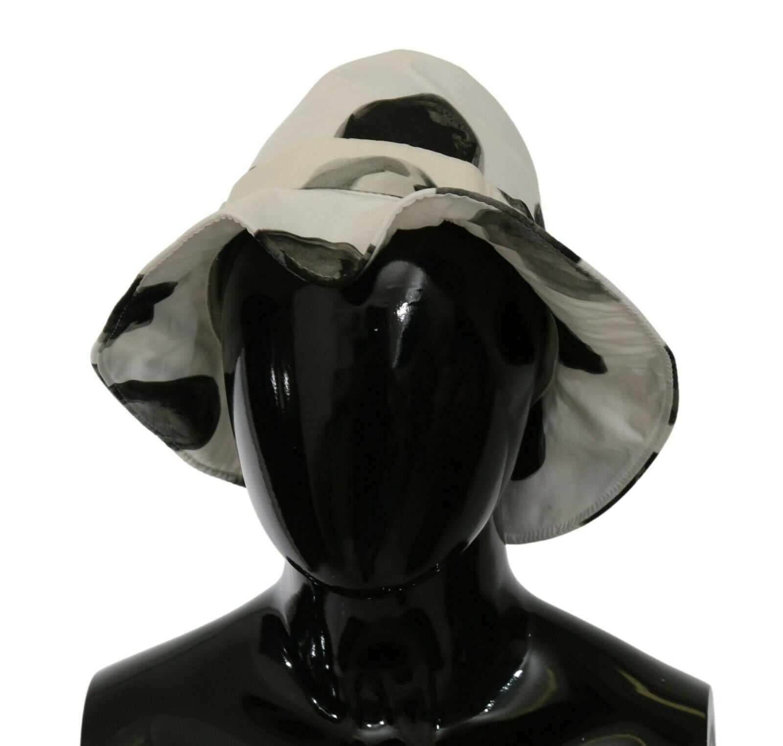 White cotton bucket hat with large black polka dot pattern by Dolce & Gabbana, featuring a wide brim and casual style.