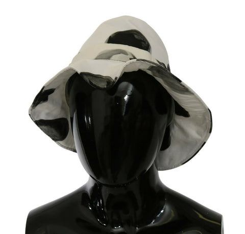 White cotton bucket hat with large black polka dot pattern by Dolce & Gabbana, featuring a wide brim and casual style.