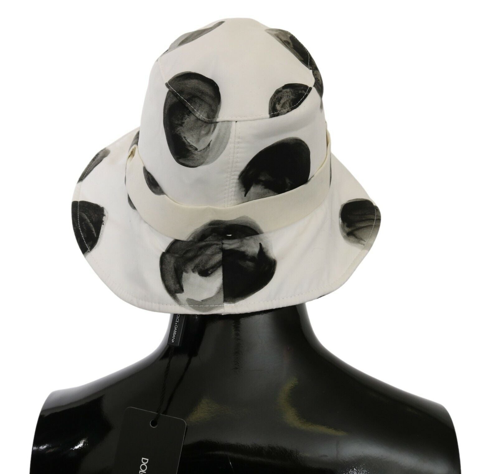 White cotton bucket hat with large black polka dot pattern by Dolce & Gabbana, casual summer accessory.