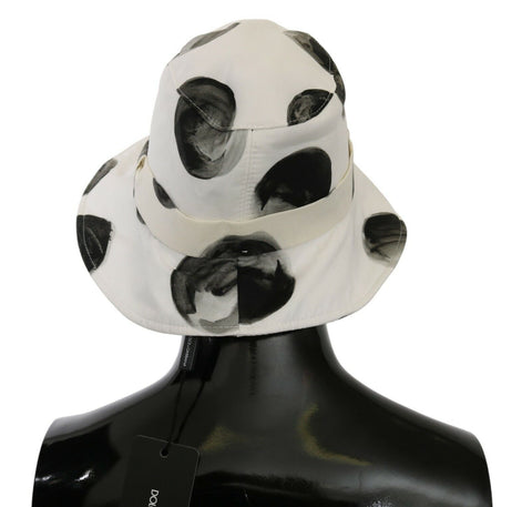 White cotton bucket hat with large black polka dot pattern by Dolce & Gabbana, casual summer accessory.