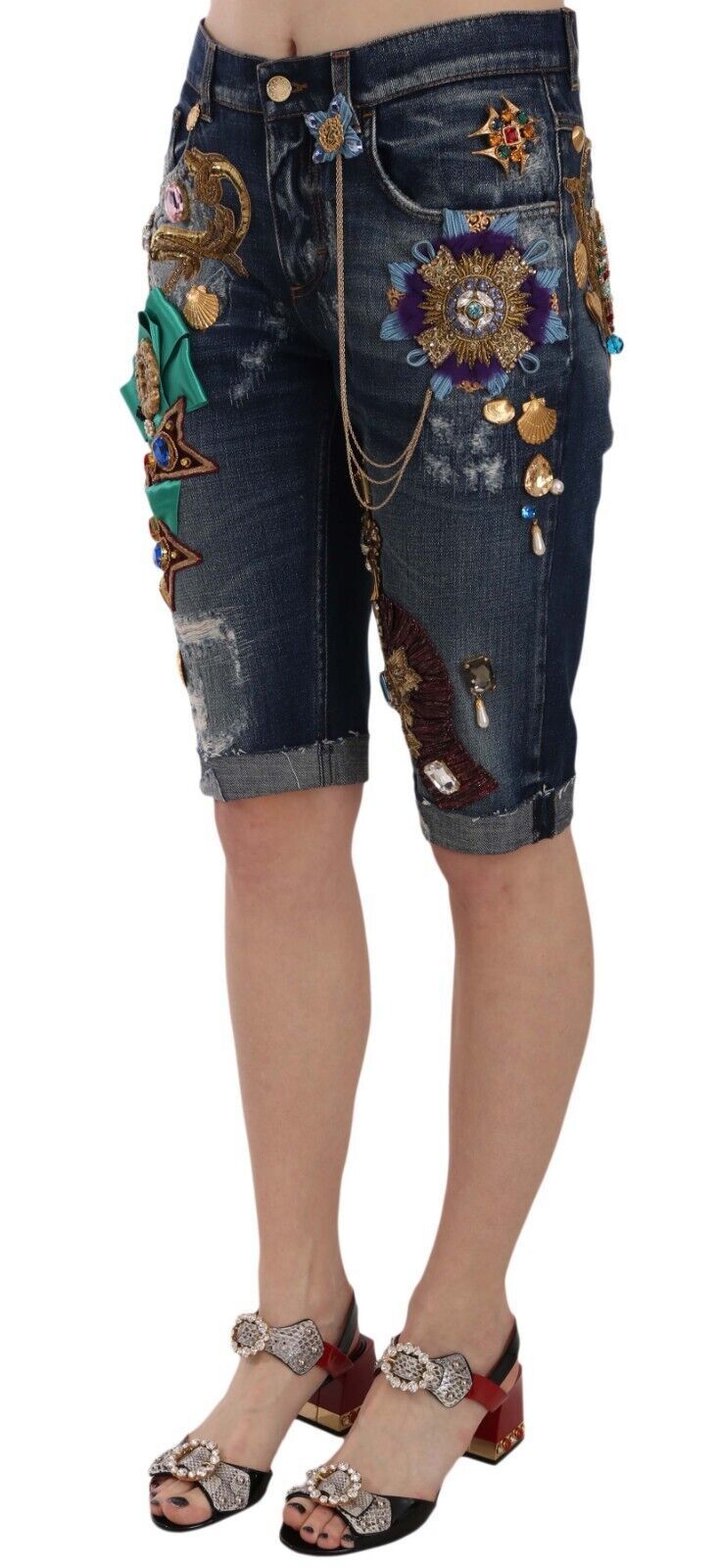 Blue denim mid-waist Capri shorts with crystal embellishments by Dolce & Gabbana, shown on a model.