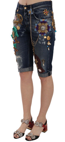 Blue denim mid-waist Capri shorts with crystal embellishments by Dolce & Gabbana, shown on a model.