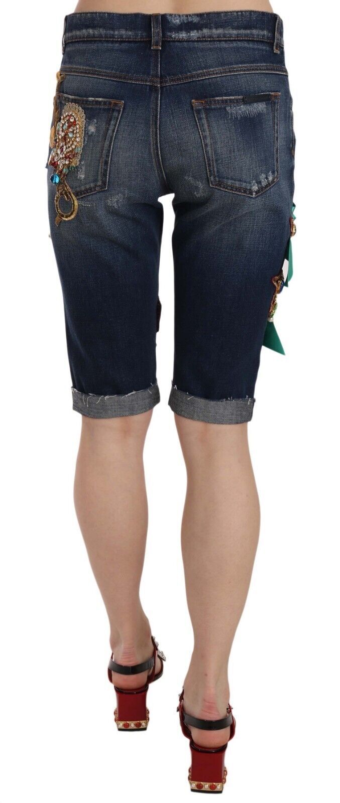 Blue denim mid waist Capri shorts with crystal embellishments by Dolce & Gabbana, featuring a stylish and fitted design.