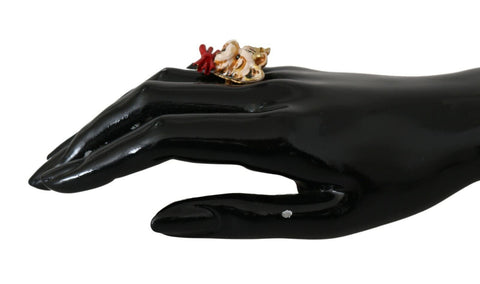 Beige dog-themed pet accessory with gold brass resin ring, branded by Dolce & Gabbana, featuring detailed design and elegant craftsmanship.