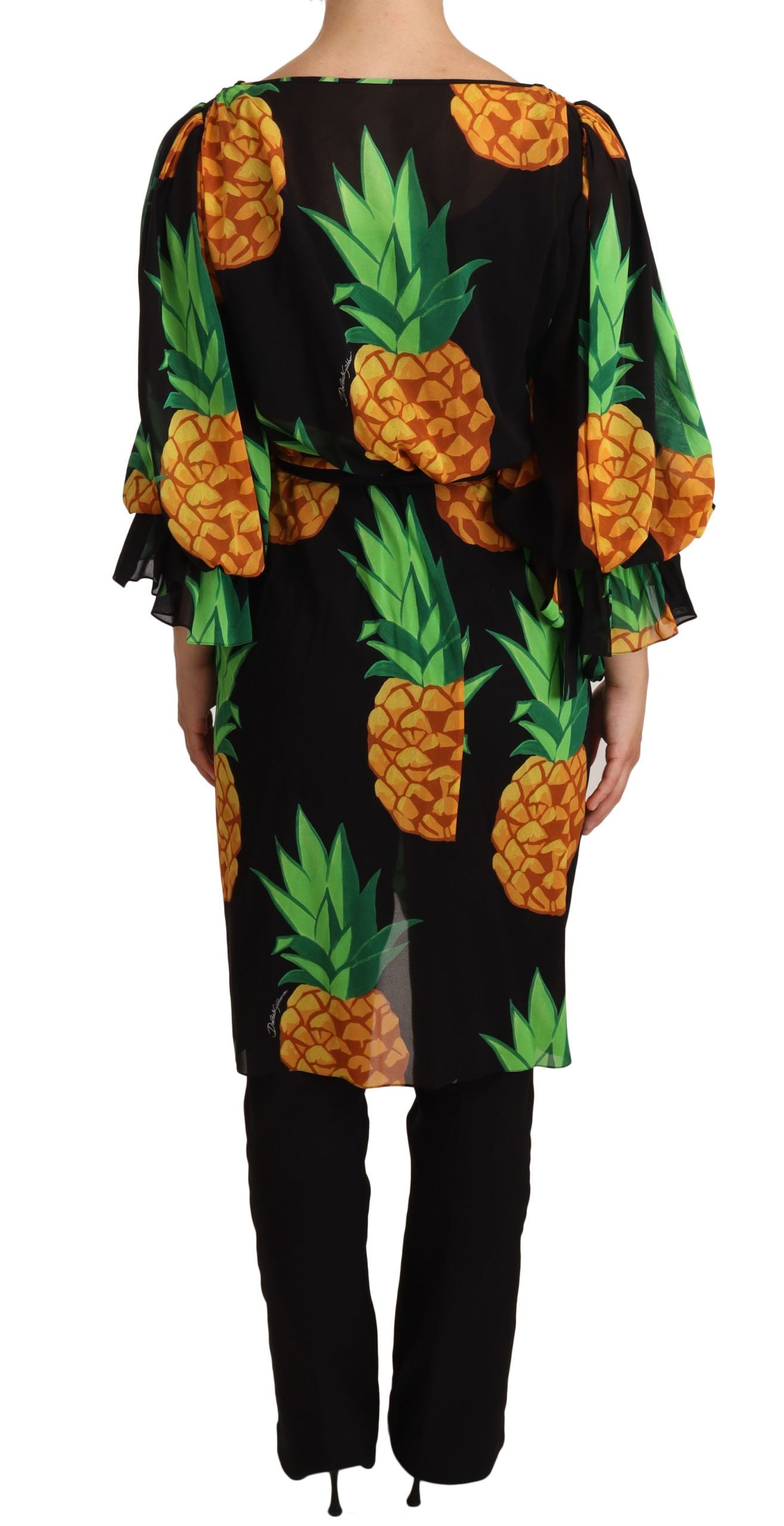 Black silk wrap dress with an ananas print from Dolce & Gabbana, showing its elegant fit and tropical pattern.