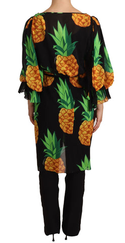 Black silk wrap dress with an ananas print from Dolce & Gabbana, showing its elegant fit and tropical pattern.