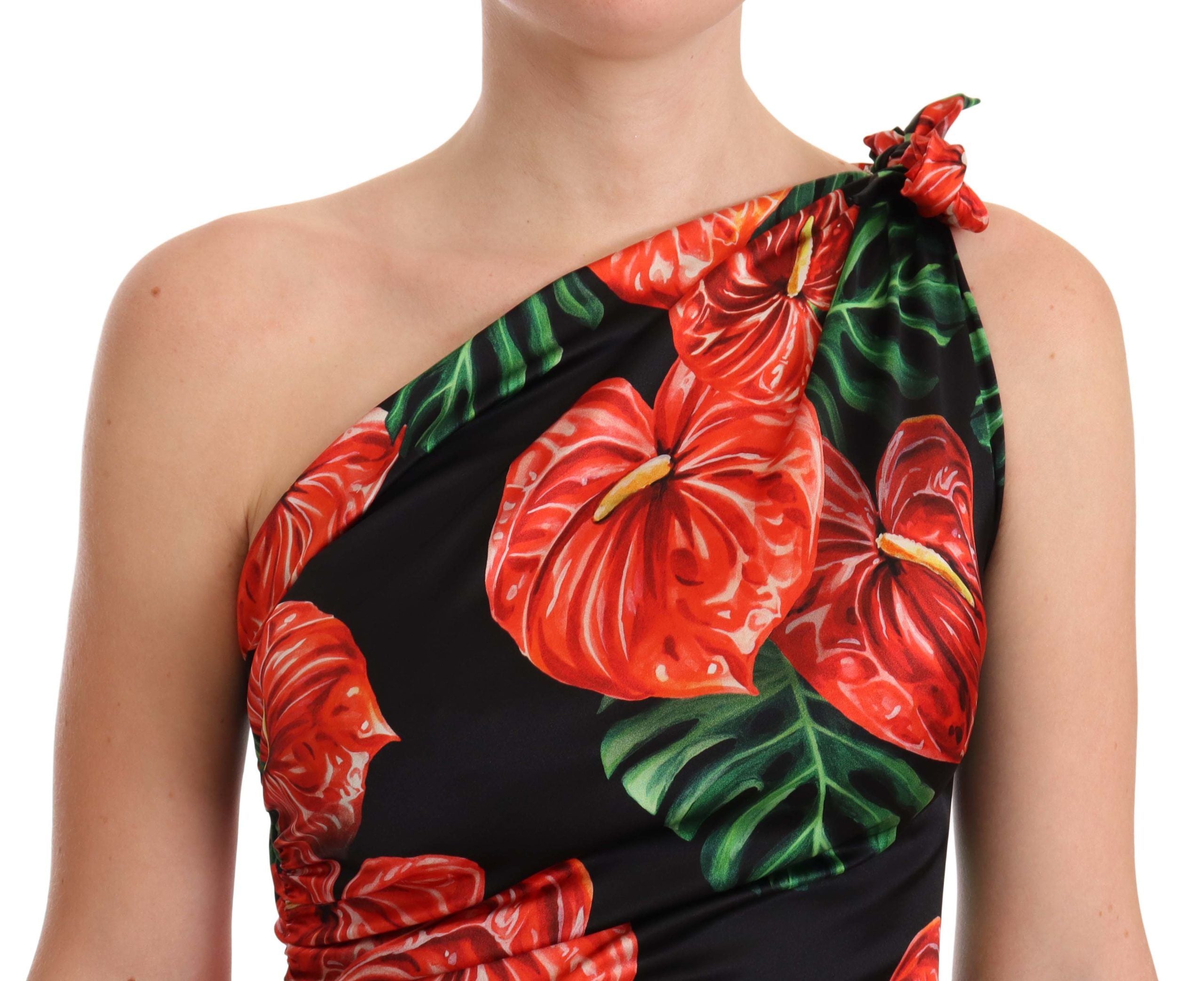 Black shiny silk floral print draped dress by Dolce & Gabbana, showing a flowing elegant design with floral patterns.