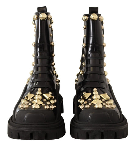 Black leather studded combat boots by Dolce & Gabbana with chunky soles and metal stud accents, stylish and sturdy footwear.