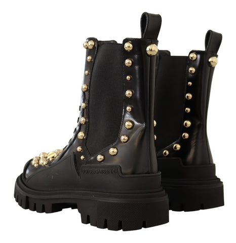 Black leather studded combat boots by Dolce & Gabbana with rugged design and metal stud accents, perfect for edgy fashion.