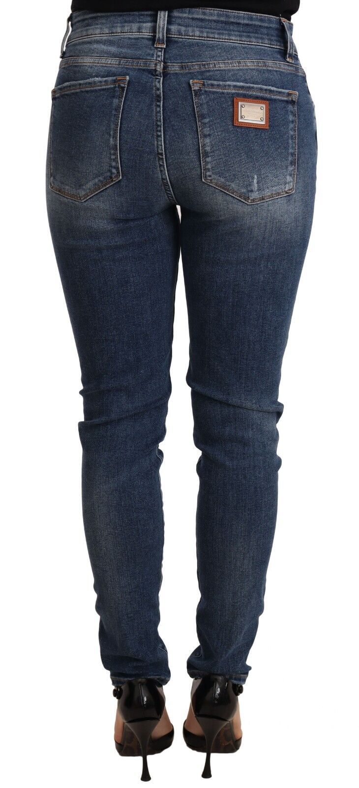 Blue wash skinny denim jeans by Dolce & Gabbana, made of cotton stretch fabric, displayed on a hanger.