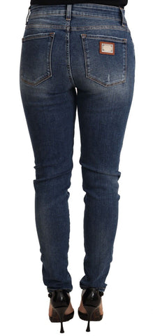 Blue wash skinny denim jeans by Dolce & Gabbana, made of cotton stretch fabric, displayed on a hanger.