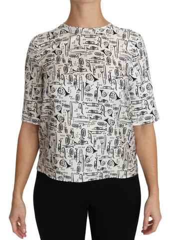 White blouse with musical instrument print by Dolce & Gabbana, featuring long sleeves and a stylish, elegant design.