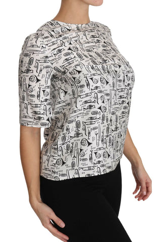 White blouse by Dolce & Gabbana with musical instruments print, featuring a stylish, elegant design perfect for fashionable wear.